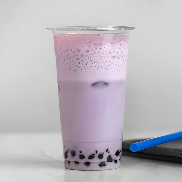 Vigo Coffee Smoothies & Tea's taro bubble tea with a blue straw on a white surface.